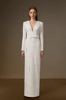 White embellished V-neck column gown by I.H.F with flowing water effect embellishments, elegant crepe fabric, and sleek silhouette.