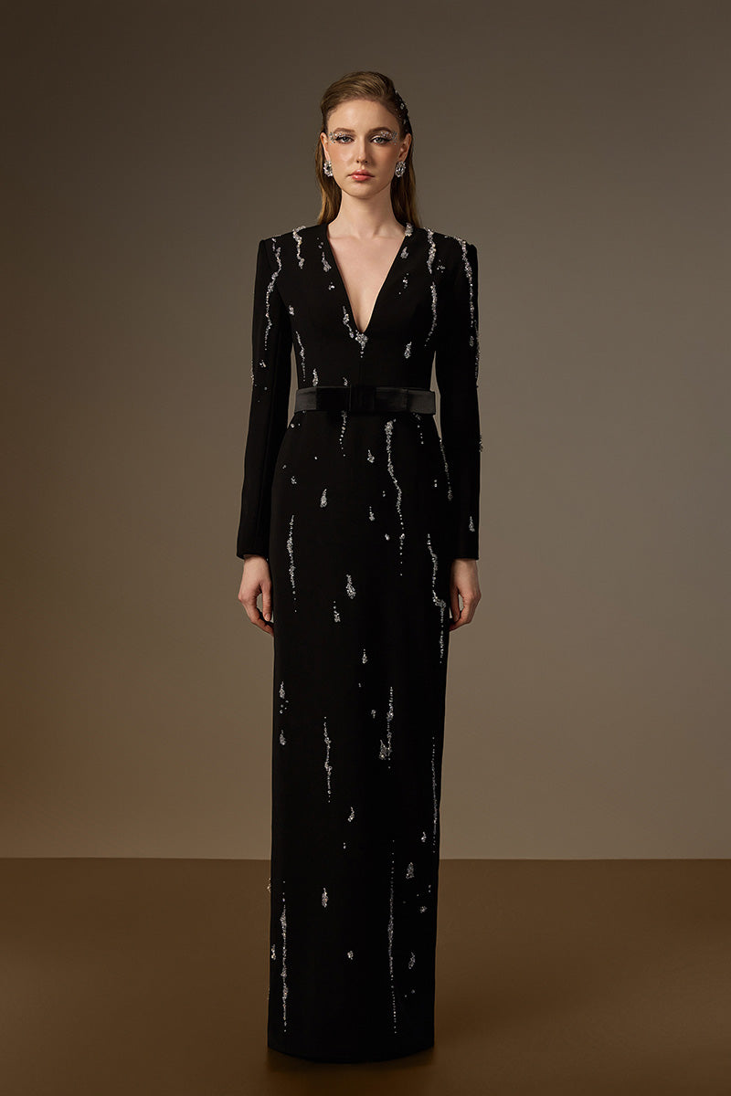 Seraphina black embellished V-neck column gown by I.H.F featuring flowing water effect embellishments on black crepe fabric.
