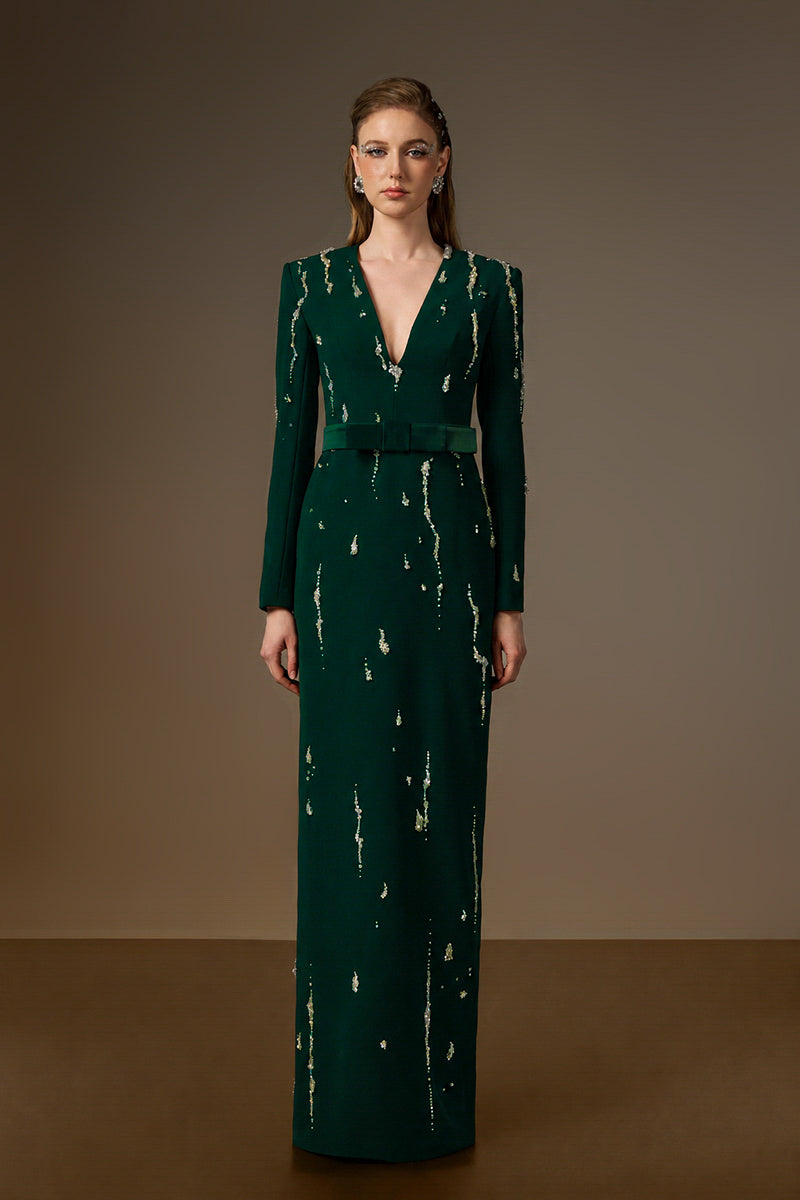 Dark green Seraphina gown by I.H.F featuring a V-neck, column silhouette, and flowing water effect embellishments in crepe fabric.