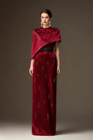 Red metallic asymmetric cape gown by I.H.F featuring a round neck and sleek column silhouette in dark red silk.