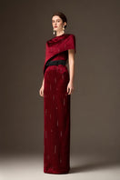 Valentina red metallic asymmetric cape gown by I.H.F featuring a round neck, column silhouette, and dark red metallic silk fabric.