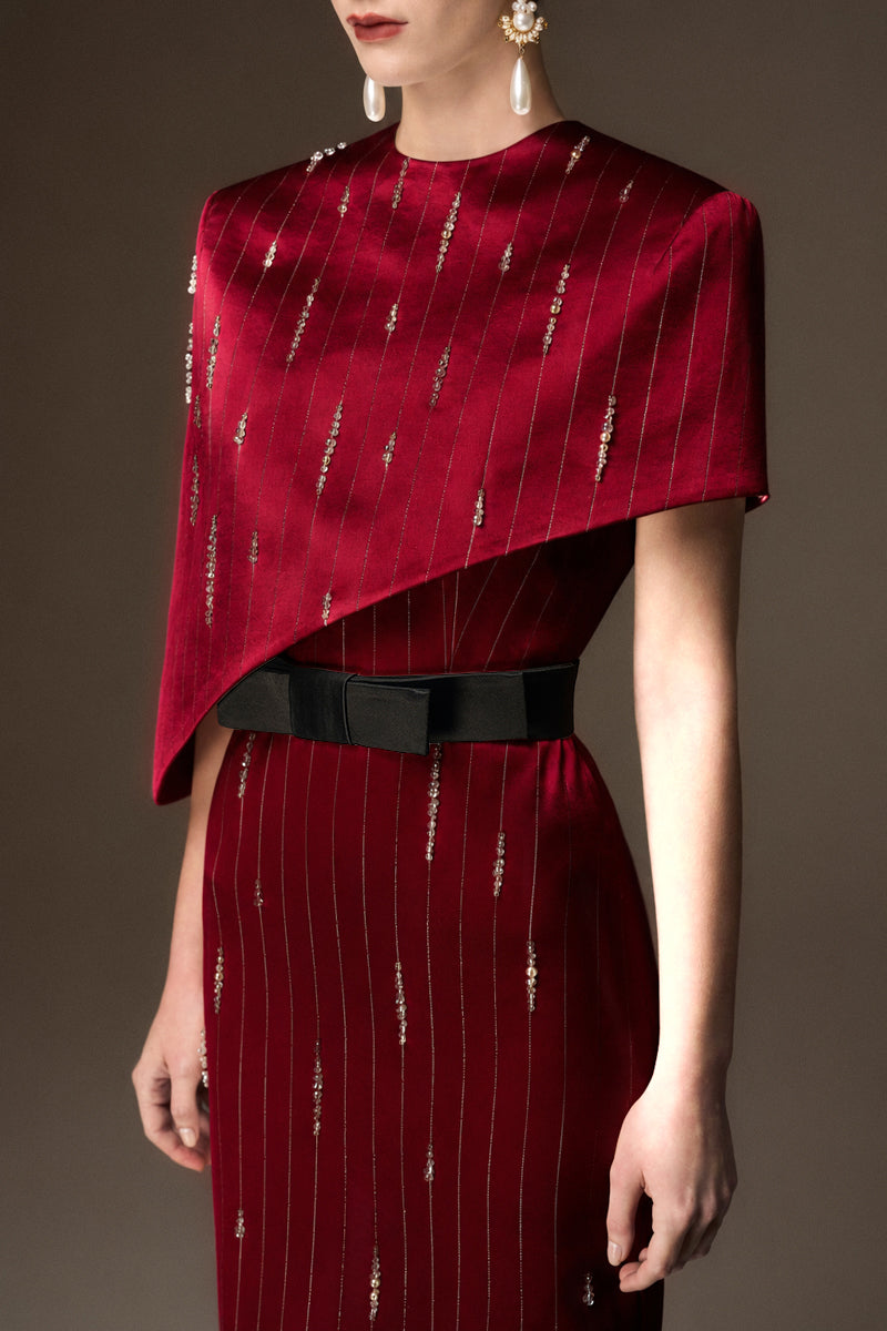 I.H.F red metallic asymmetric cape gown with round neck and sleek silhouette, featuring strip silk fabric for an elegant evening look.