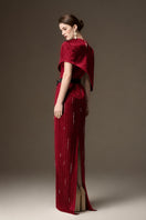 Red metallic asymmetric cape gown by I.H.F featuring a round neck and sleek column silhouette in dark red stripped silk.