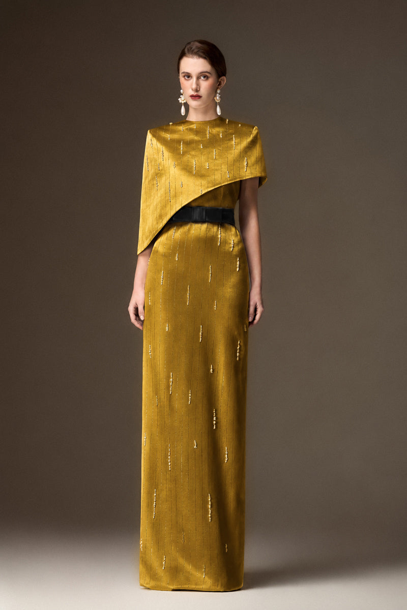 Yellow metallic asymmetric cape gown by I.H.F, featuring a round neck and elegant, flowing silk design.