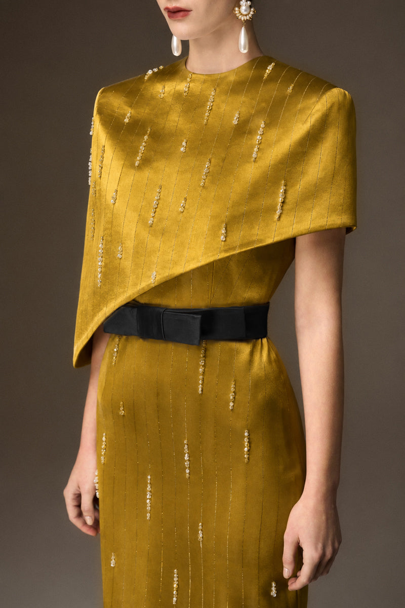 Yellow metallic asymmetric cape gown by I.H.F, featuring a round neck and sleek column silhouette in luxurious silk.