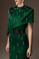 Dark green metallic asymmetrical cape gown by I.H.F, featuring a round neck and elegant flowing silhouette.