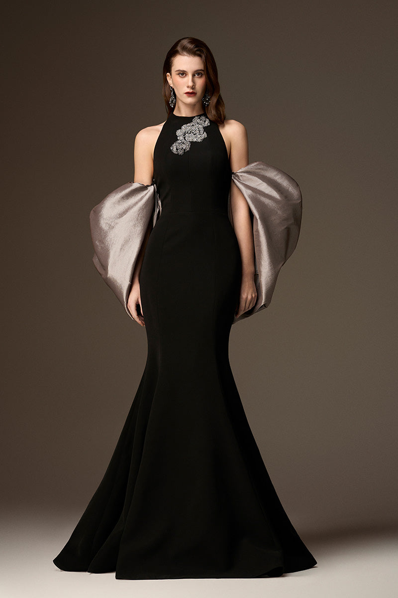 Jessica black and silver draped train mermaid gown by I.H.F, featuring a round neck, black crepe, and grey taffeta with elegant back train.