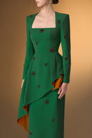 Green crepe gown with trapeze neckline and diagonal hip drape, stylish I.H.F dress perfect for elegant occasions.