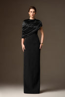 Black satin and crepe asymmetric cape column gown by I.H.F featuring a round neck and elegant design.
