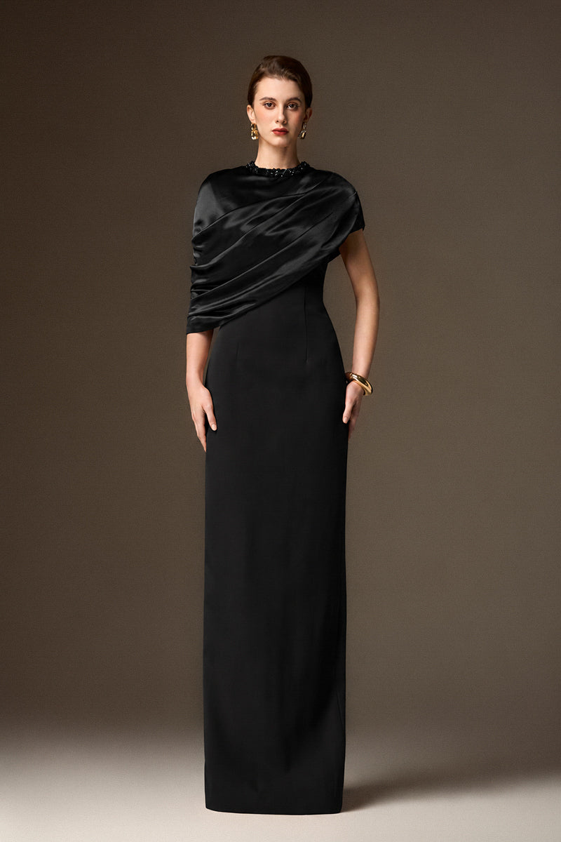 Black satin and crepe asymmetric cape column gown by I.H.F featuring a round neck and elegant design.