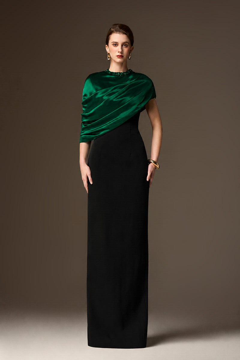 Elegant black and green asymmetrical cape column gown by I.H.F featuring green satin silk and black crepe fabric.