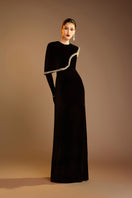 Valenciani black gown with gem-embellished trim cape, elegant formal dress with intricate detailing and flowing fabric.