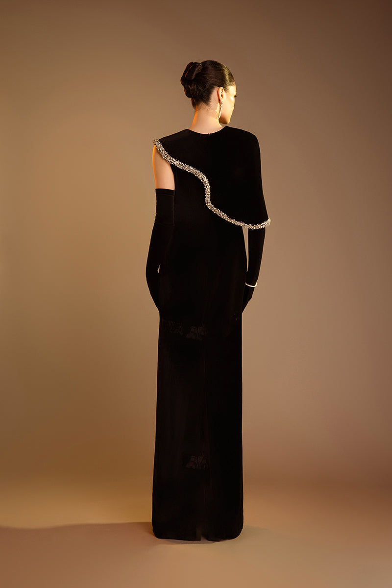 Valenciani black gown with gem-embellished trim cape, elegant formal dress with intricate detailing and flowing fabric.
