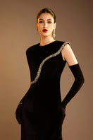 Black Valenciani gown with gem-embellished trim cape, elegant formal dress with intricate detailing and flowing fabric.