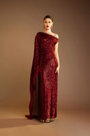 Red Valenciani one-shoulder draped sequin gown, elegant evening dress with shimmering embellishments and flowing silhouette.