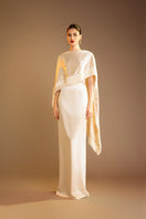 Cream Valenciani column gown with fringed trim cape, elegant floor-length dress with flowing silhouette and stylish detailing.