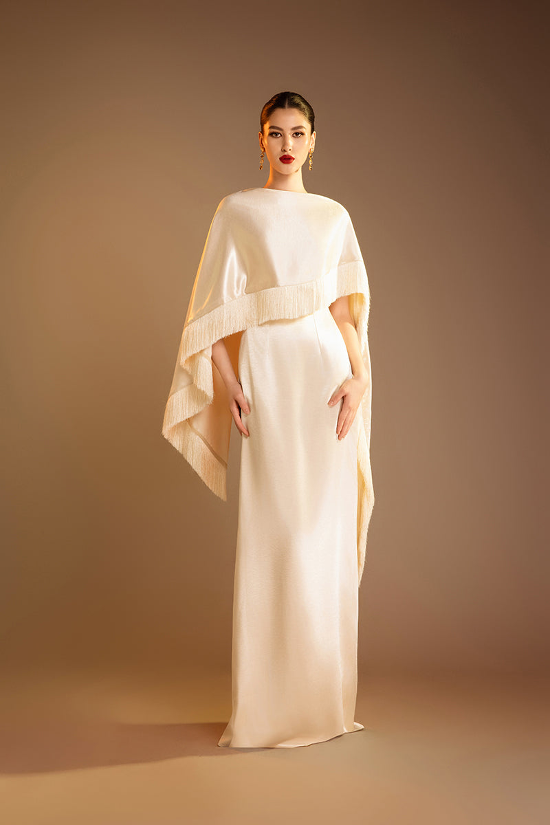 Cream Valenciani column gown with fringed trim cape, elegant evening dress with flowing silhouette and stylish details.