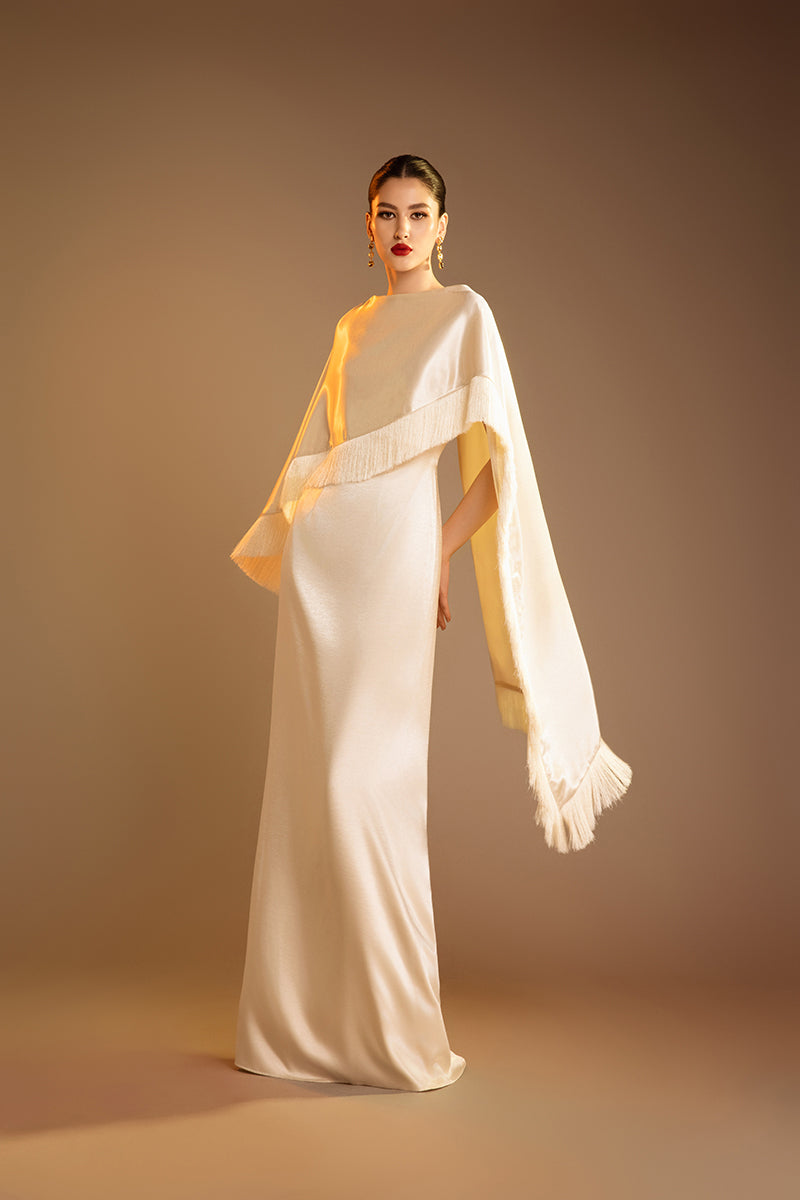 Cream Valenciani column gown with fringed trim cape, elegant floor-length evening dress with stylish detailing.