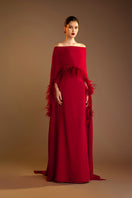 Red Valenciani ostrich feather trim cape dress featuring elegant gown design with feather accents, perfect for special occasions.