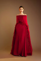 Red Valenciani gown with ostrich feather trim cape, elegant evening dress with flowing fabric and luxurious feather accents.
