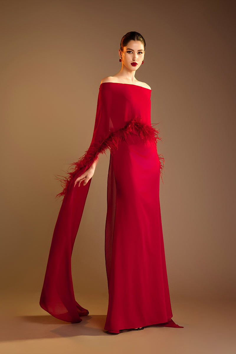 Red Valenciani gown with ostrich feather trim cape, elegant formal dress featuring luxurious feather accents and flowing fabric.