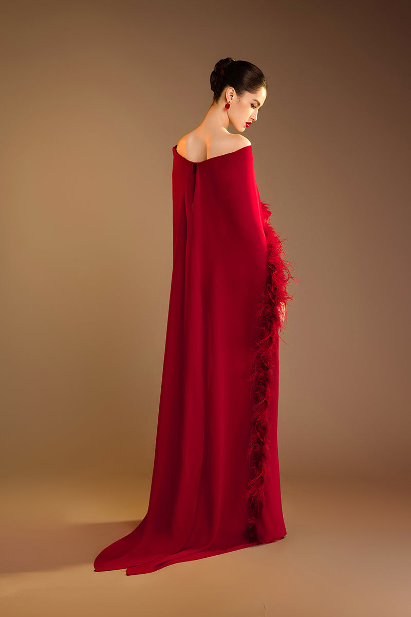 Red Valenciani ostrich feather trim cape dress with elegant gown design, featuring feather accents and flowing fabric.