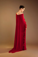 Red Valenciani ostrich feather trim cape gown, elegant evening dress with feathered accents and flowing fabric.