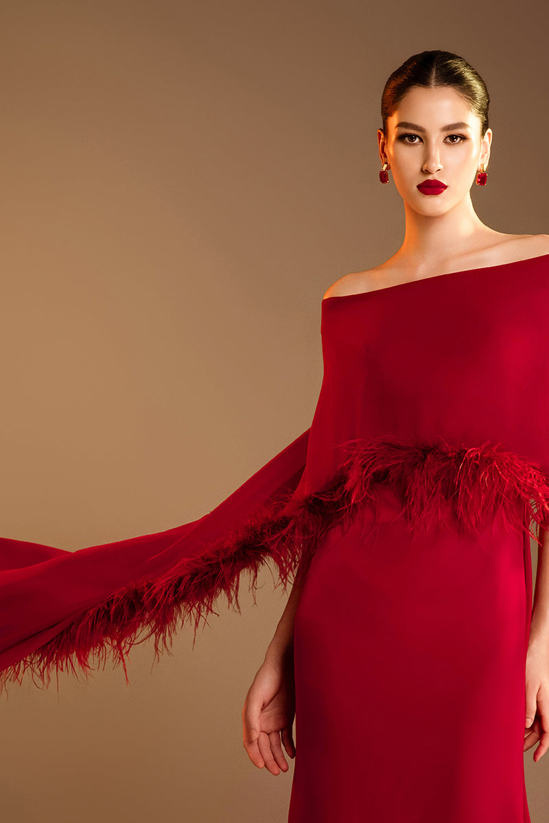 Red Valenciani gown with elegant ostrich feather trim cape, featuring luxurious fabric and sophisticated design.