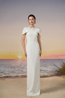 White Serra Crepe Dress gown by 21Six displayed on a mannequin, featuring elegant draping and a sleek, sophisticated silhouette.