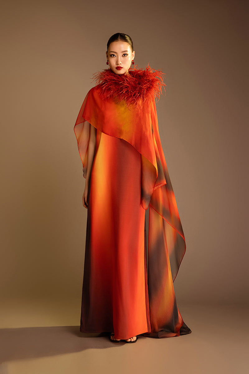 Valenciani printed orange gown with a detachable ostrich feather trim cape, elegant evening dress with intricate design.