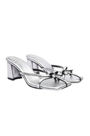 Silver Christin Wu Adrianna sandals with strappy design and open toe, showcased on a neutral background.
