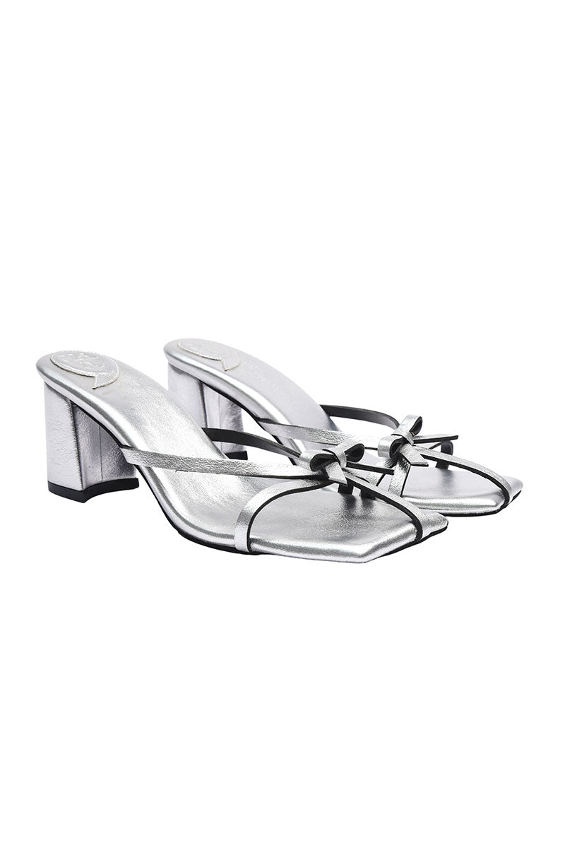 Silver Christin Wu Adrianna sandals with strappy design and open toe, showcased on a neutral background.