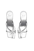 Silver Christin Wu Adrianna sandals with open toes and ankle straps, showcased on a neutral background.