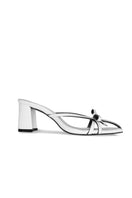 White Christin Wu Adrianna sandals with open toes and ankle straps, photographed on a neutral background.