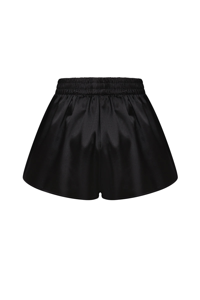 Black satin boxer shorts by ELENAREVA, featuring smooth fabric and relaxed fit, shown laid flat with waistband and leg openings visible.