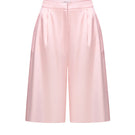 Pink satin wide-leg shorts by ELENAREVA, featuring smooth fabric and relaxed fit, shown on a hanger.