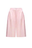 Pink satin wide-leg shorts by ELENAREVA, featuring smooth fabric and relaxed fit, shown on a hanger.