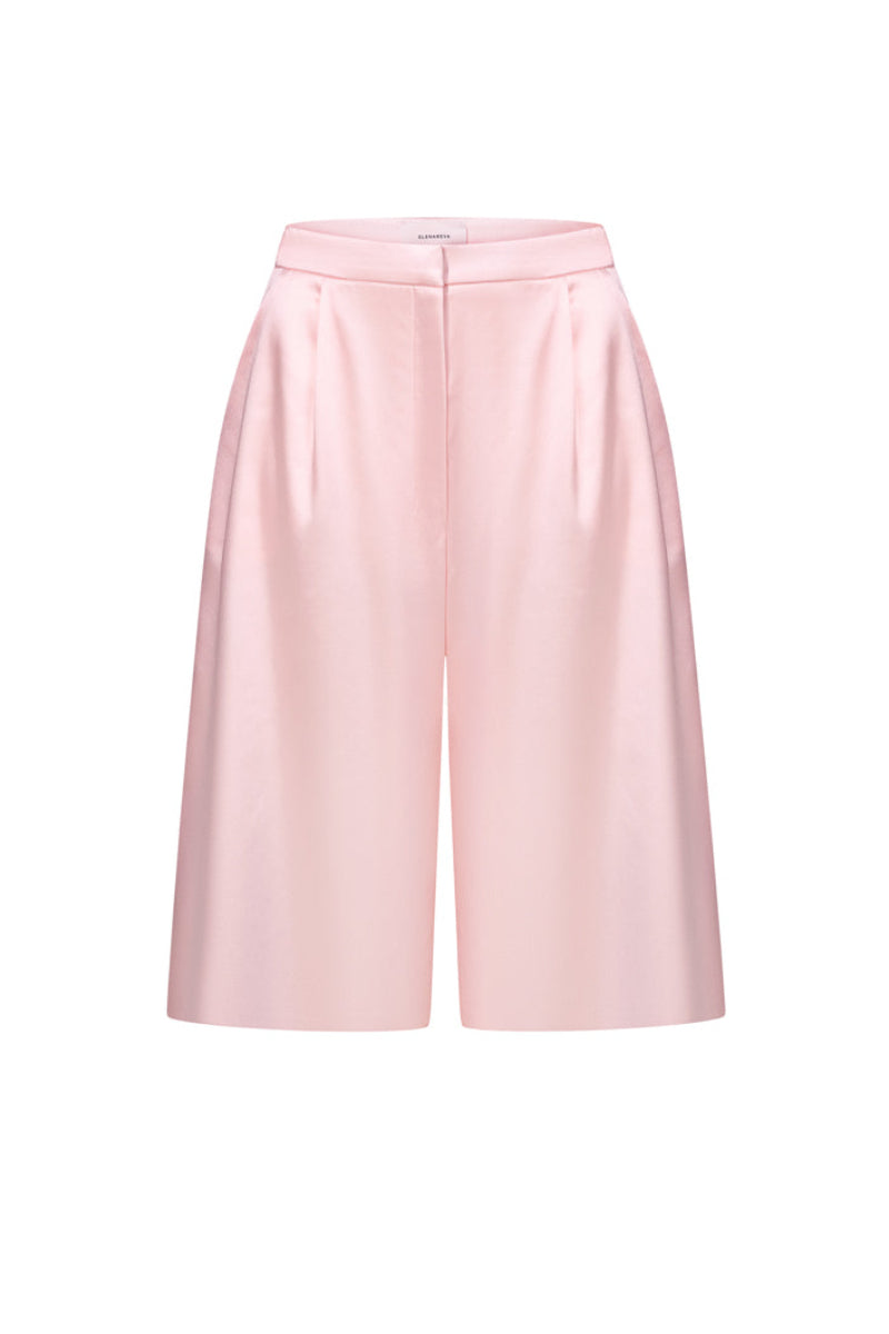 Pink satin wide-leg shorts by ELENAREVA, featuring smooth fabric and relaxed fit, shown on a hanger.