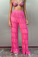 Andrea Iyamah SINA regular pants in vibrant magenta, showcasing the stylish fit and smooth fabric of these fashionable pants.