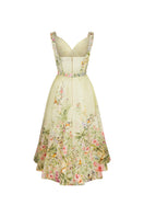 AISA Gardenia floral midi dress displayed on a hanger, featuring a vibrant botanical print and flowing fabric.