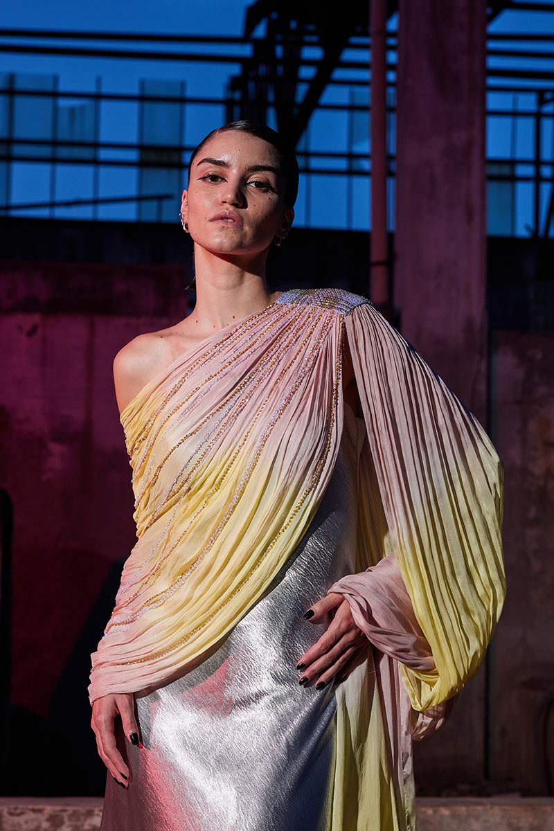 Elegant draped chiffon sequin gown by AKHL featuring flowing fabric and sparkling details, perfect for formal occasions.