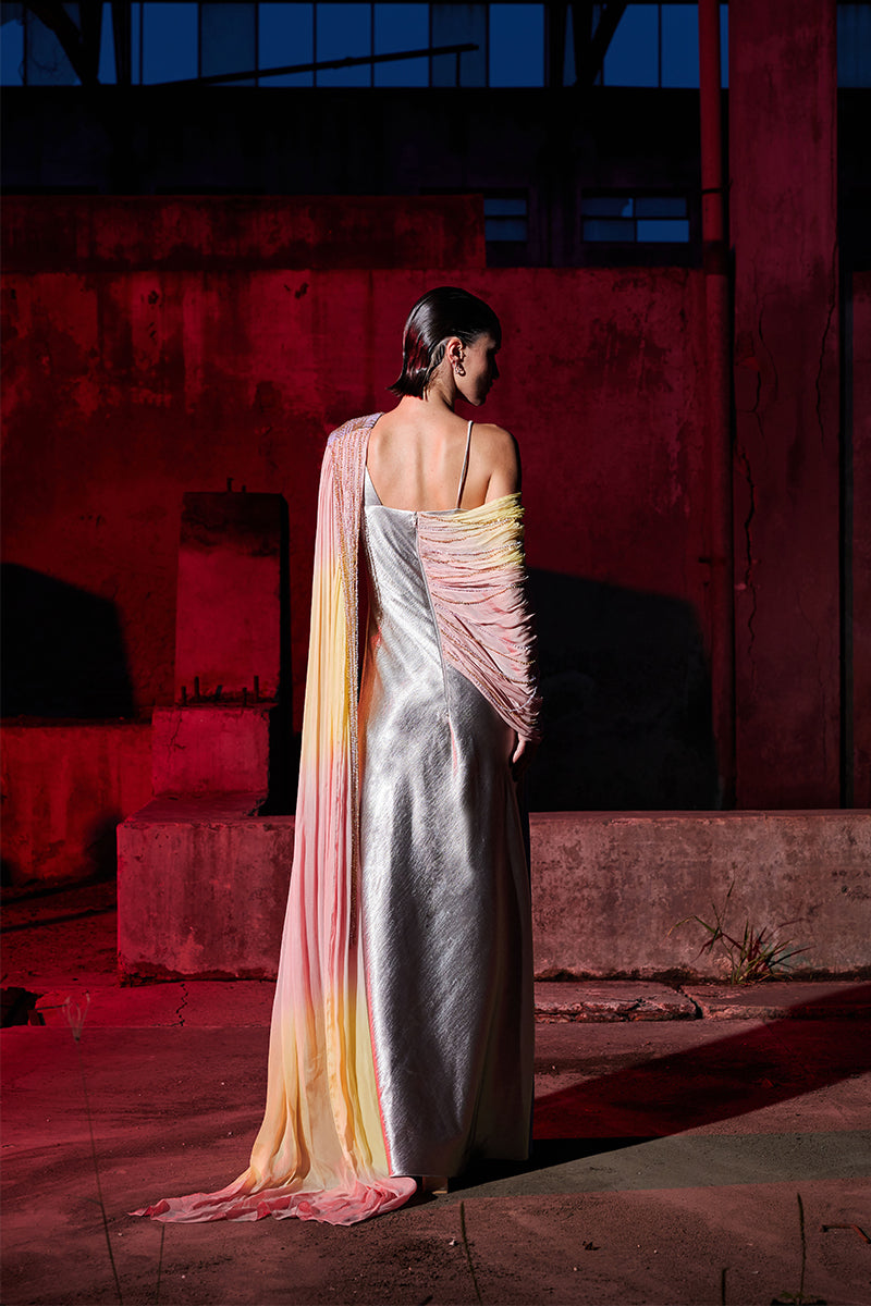 Elegant draped chiffon gown with sequin embellishments by AKHL, featuring flowing fabric and intricate detailing.