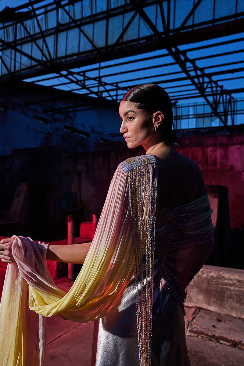 Elegant draped chiffon sequined gown by AKHL featuring flowing fabric and shimmering embellishments for formal occasions.