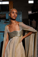 Metallic gold wave bustier kaftan gown by AKHL featuring a shimmering wave design and flowing fabric for elegant evening wear.