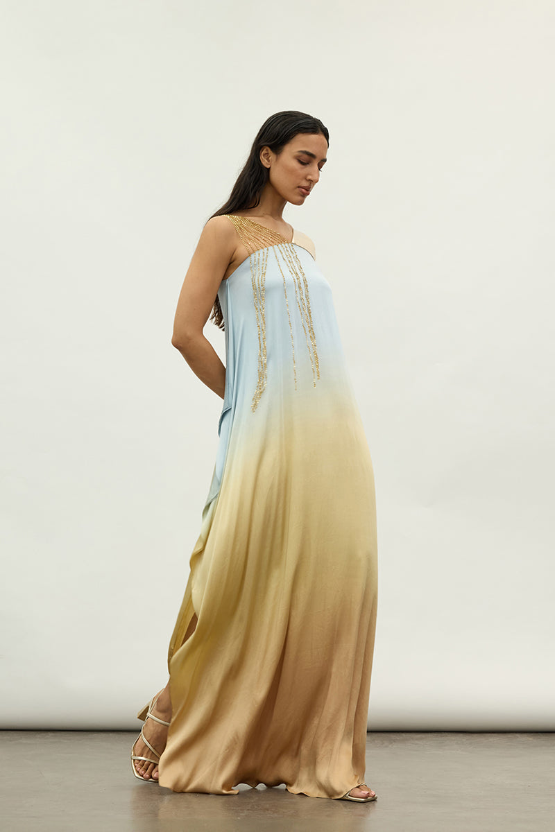 Silver sequins and metallic accents on an asymmetric maxi dress by AKHL, featuring a flowing design and elegant style.