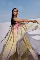 Elegant sunset-colored gown from AKHL's Interwoven Sunset Dress collection, featuring flowing fabric and intricate details.