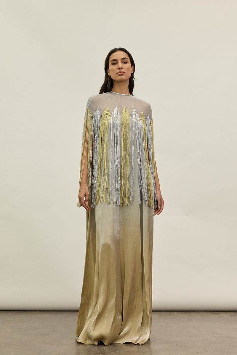 Gold and silver metallic kaftan gown by AKHL featuring shimmering fabric and elegant design, displayed on a neutral background.