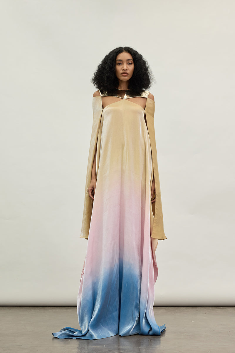 Elegant gold spectrum gown by AKHL featuring flowing fabric and intricate detailing, perfect for formal occasions.