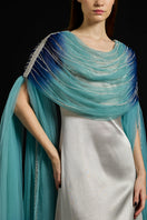 Elegant draped tulle fall-panelled gown by AKHL with flowing fabric and intricate detailing, perfect for formal occasions.