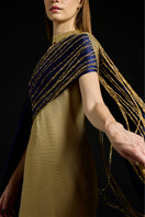 Metallic draped sequin gown by AKHL featuring a shimmering, elegant design with flowing fabric and intricate sequin details.